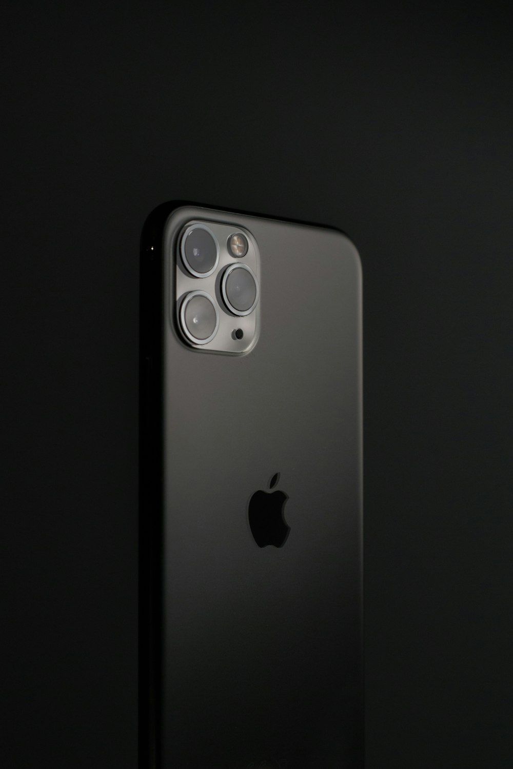 Back of a black iPhone on a dark background